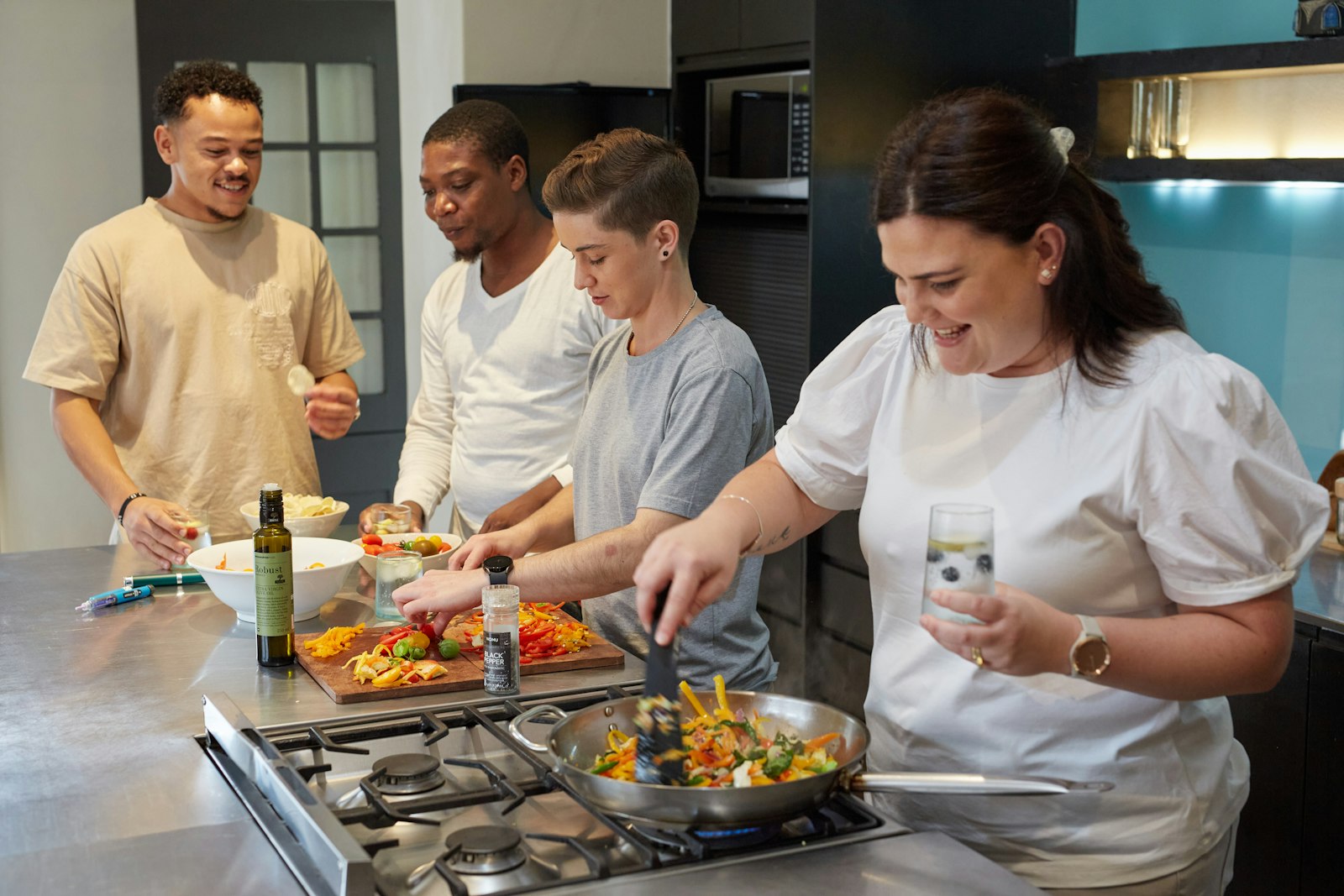 A group of people preparing food together in a kitchen